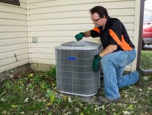 Technician working on an external HVAC unit